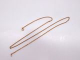 a gold necklace with a chain that has a heart on it