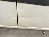 a close up of a car door with rust on the side