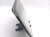 a tablet computer sitting on a stand on a table