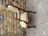 a chair that is sitting on the side of a brick wall