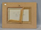 a close up of a picture frame with a piece of paper sticking out of it