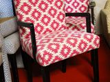 two chairs that are next to each other on a red carpet