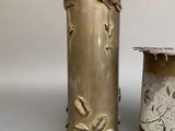 two vases sitting next to each other on a table