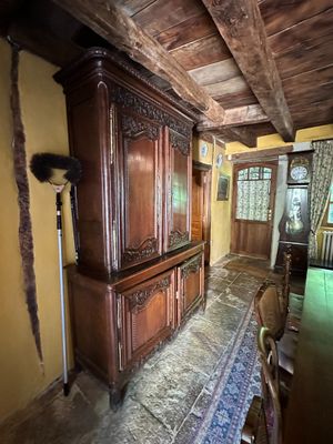 a large wooden cabinet in the middle of a room