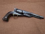 a gun that is laying on top of a brown cloth