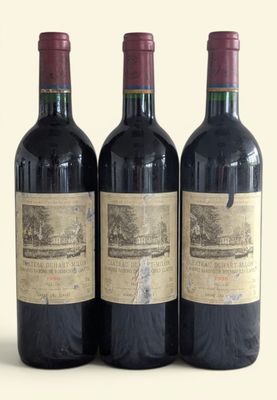 three bottles of wine sitting next to each other on a table