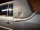 a silver car with a sticker on the side of it