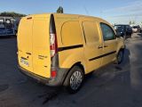 a yellow van that is parked in a parking lot
