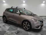the grey car is parked on a checkered floor in the garage