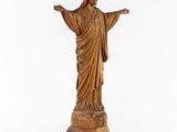 a statue of jesus on a pedestal with his arms outstretched