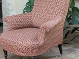 a chair that is sitting in front of a potted plant