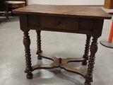 a small table with a drawer on it in a room