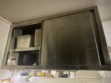 a stainless steel cabinet above a sink in a kitchen