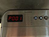 a digital clock on top of a toaster oven