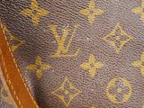 a close up of a louis vuitton bag on a table