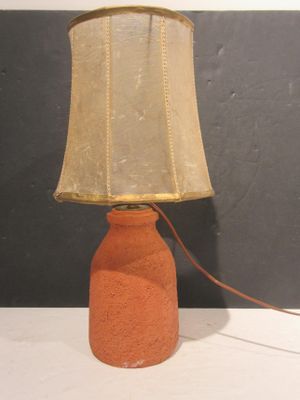 a lamp that is sitting on a table with a lamp shade on it