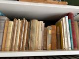 many books that are on a shelf in the room