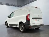 the rear end of a white van parked in a garage