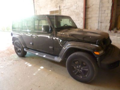 a black jeep that is parked in a garage
