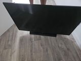 the television is sitting on a stand in the corner of the room