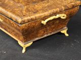 a small wooden box that is sitting on a black surface