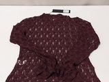 the top of a sweater on a white surface with a white background