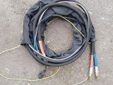 a hose that is laying on the ground next to some wires