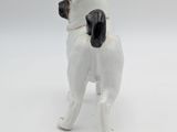 a small figurine of a pug dog on a white surface
