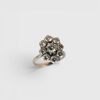 a close up of a diamond ring on a white surface