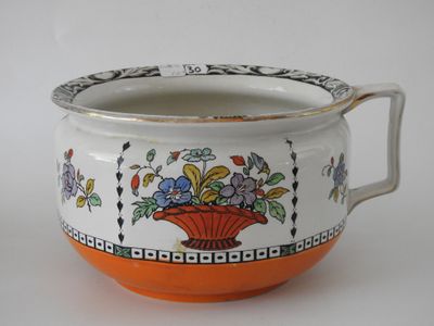 an orange and white bowl with a flower design on it