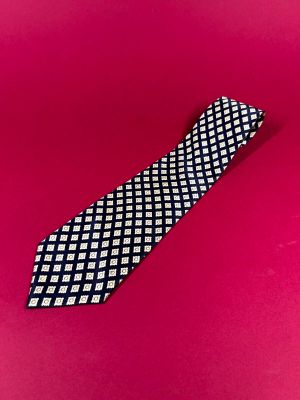 black and white checkered necktie on a pink background