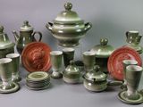 a lot of green and white dishes and cups on the table