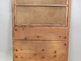 an old wooden dresser with three drawers on top of it