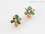 a pair of emerald and diamond earrings
