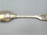 silverware spoon and spoon rest on a gray surface