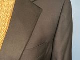a brown suit with a yellow tie on a mannequin mannequin