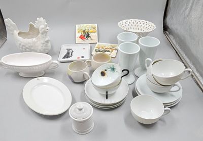 a lot of white dishes and cups on the table