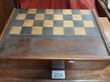 a wooden box with a chess board on top of it