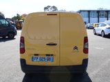 a yellow van that is parked in a parking lot