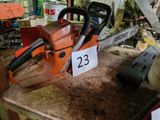 une tronçonneuse posée sur un établi dans un atelier