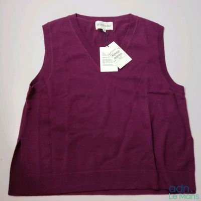 a close up of a purple sweater with a tag on it
