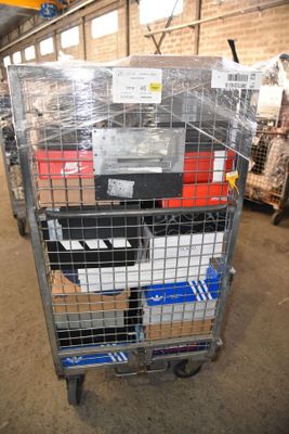 a metal cart with many boxes on it in a warehouse