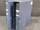 a blue binder with two books in it sitting on a table