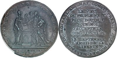 un gros plan d'une pièce d'argent sur laquelle figurent des personnages
