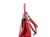 the red leather handbag is sitting on a white surface