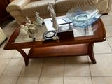 a glass table with a clock on it in a living room