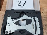 a small tool in a plastic case on a wooden table