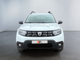 the front view of a white dacia parked in a white room