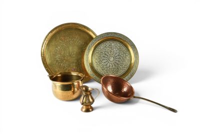 several different types of brass dishes and spoons on a white surface