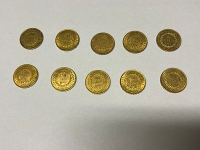 a bunch of gold coins sitting on top of a white table